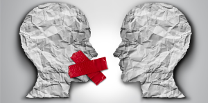 Crumpled paper in the shape of two heads facing each other. One head's mouth is covered by a giant red x representing censorship