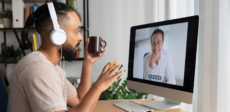 Two men having a meeting virtually over a computer